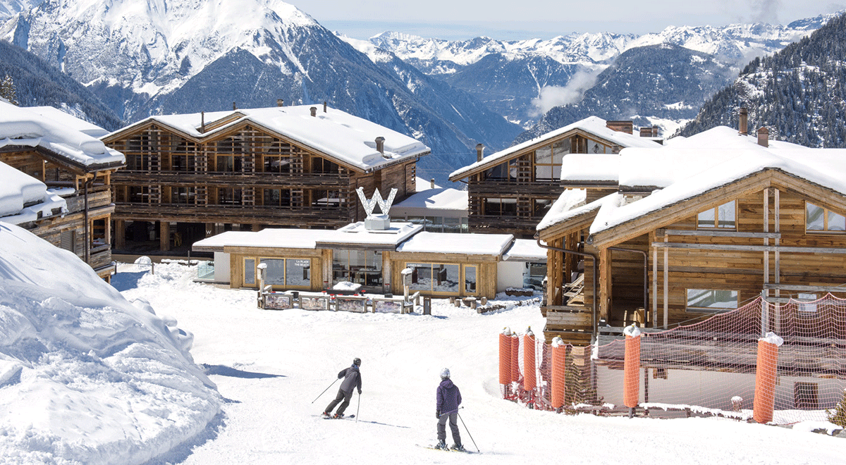Skiers in front of W Verbier in Switzerland.